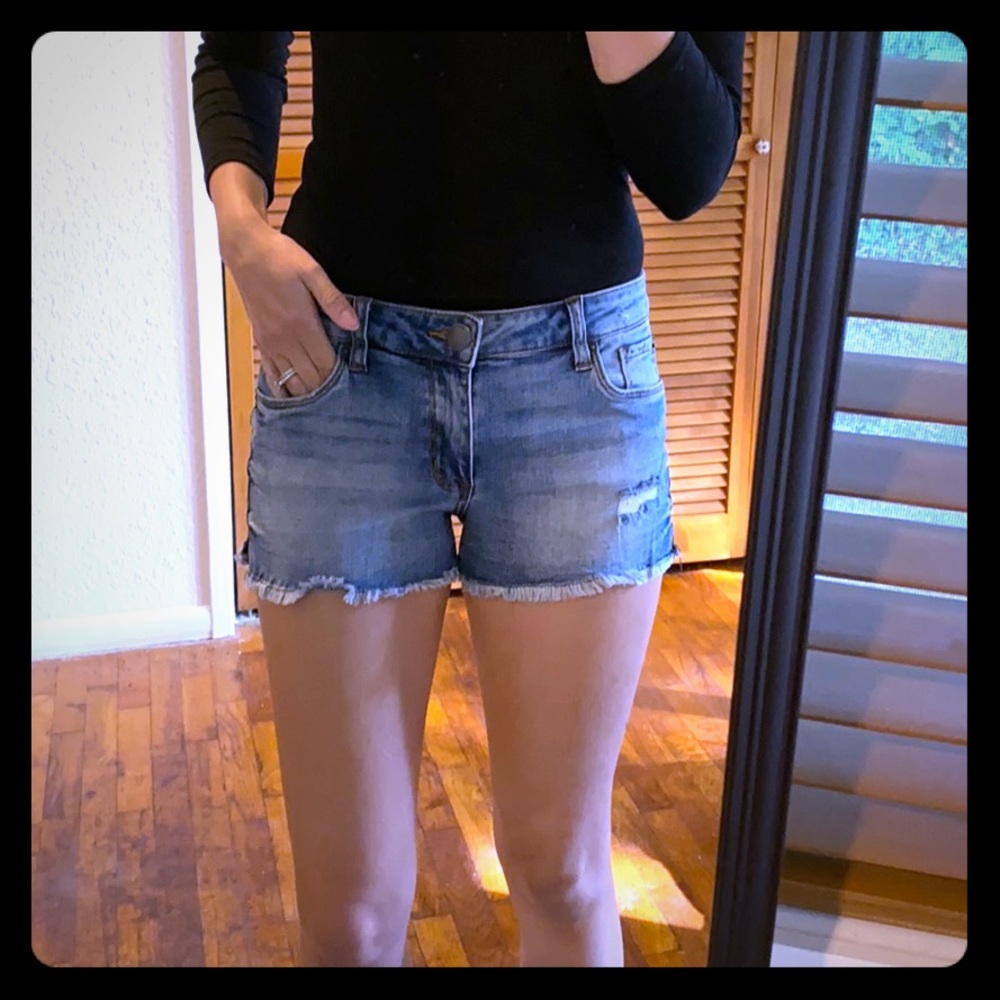 Medium wash distressed denim shorts